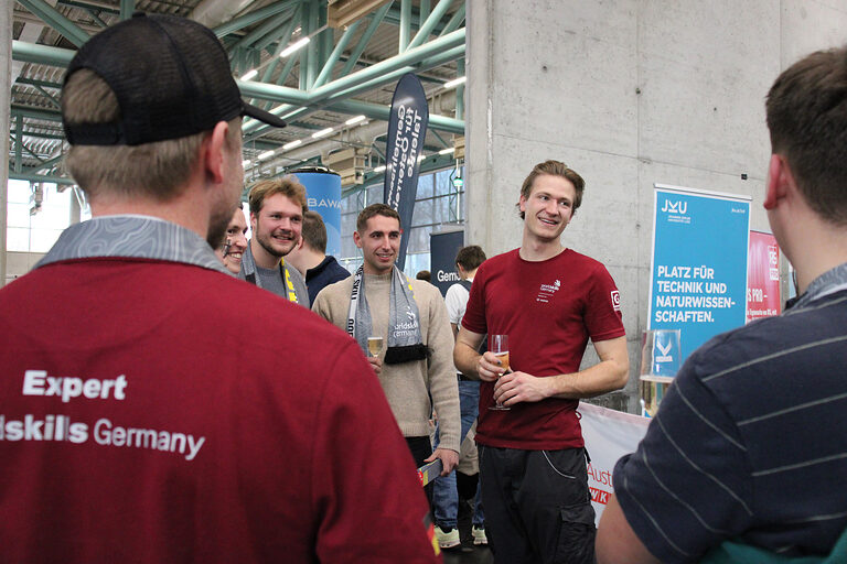 Gruppe steht nach Wettbewerb zusammen und trinkt Sekt